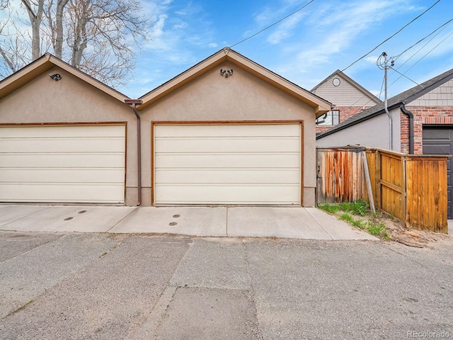 view of front of house featuring stucco siding and fence