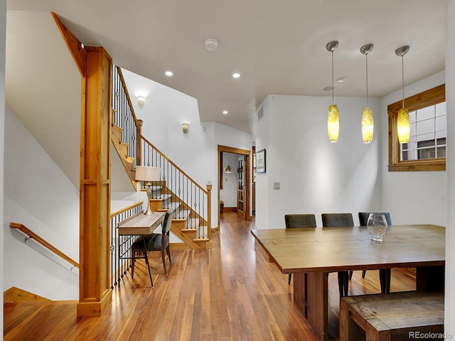 dining room featuring stairs, recessed lighting, baseboards, wood finished floors, and visible vents