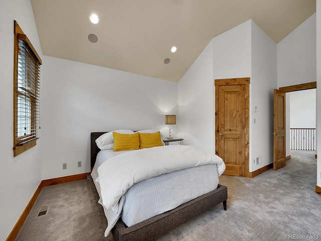 bedroom with baseboards, carpet flooring, visible vents, and high vaulted ceiling