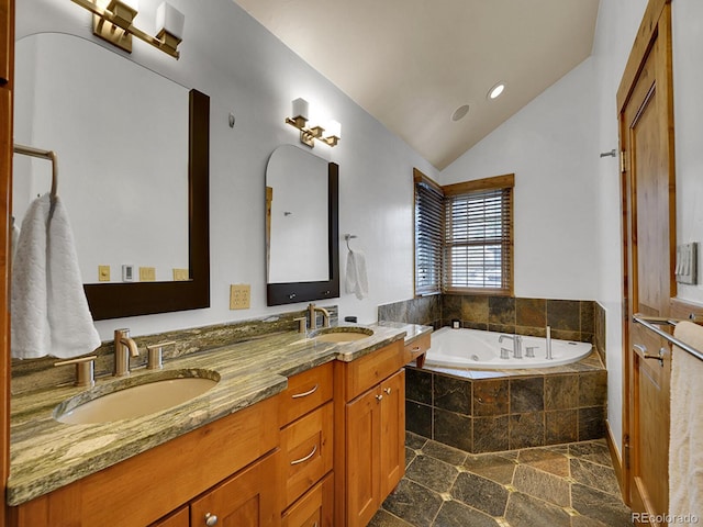 bathroom featuring a sink, a whirlpool tub, double vanity, and lofted ceiling