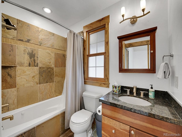 bathroom featuring toilet, shower / bath combo with shower curtain, and vanity
