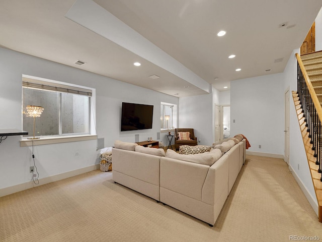 living area featuring light colored carpet, recessed lighting, visible vents, and stairway