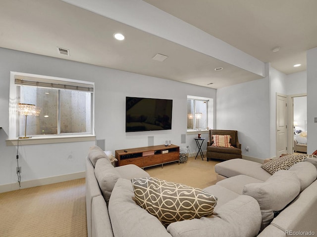 carpeted living room with recessed lighting, baseboards, and visible vents