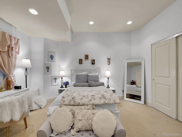 bedroom with light colored carpet, recessed lighting, and baseboards