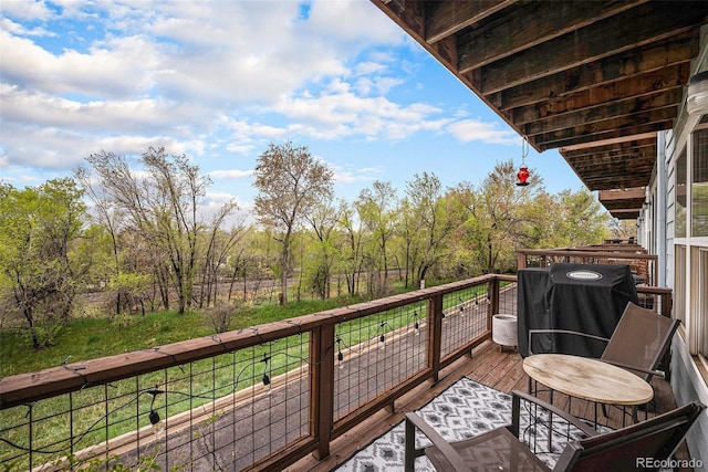 view of wooden balcony with area for grilling and a deck
