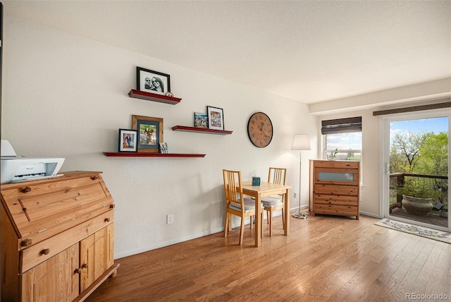 sitting room with baseboards and wood finished floors