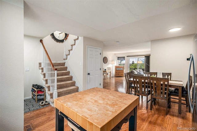 dining space with visible vents, stairs, wood finished floors, baseboards, and recessed lighting