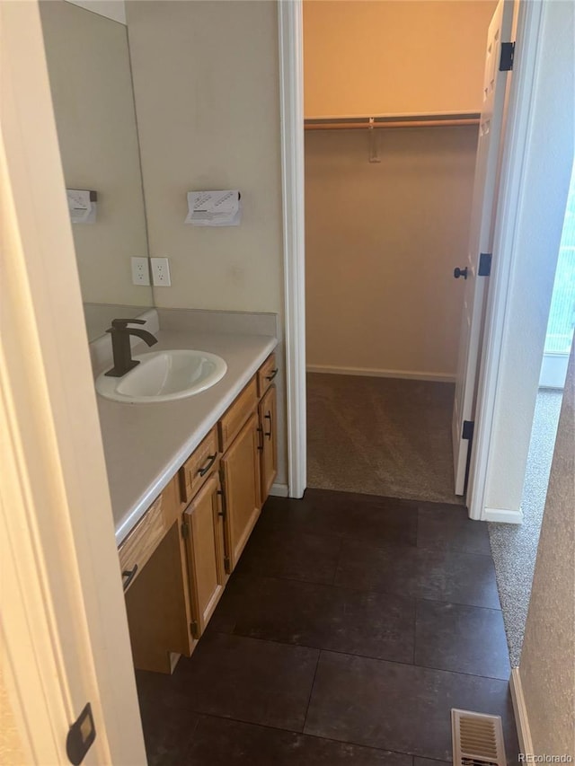 6240 Everett Ct Unit D, Arvada, CO 80004 - bathroom with vanity, a spacious closet, and tile patterned floors
