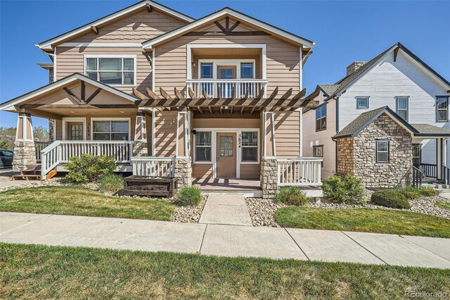 5624 Killdeer St, Brighton, CO 80601 - craftsman house with a porch, stone siding, and a pergola