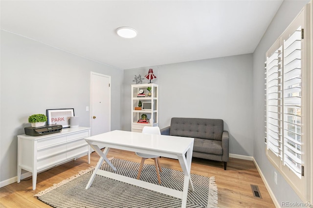 7193 S Newport Way, Centennial, CO 80112 - home office featuring light wood-style flooring and healthy amount of natural light