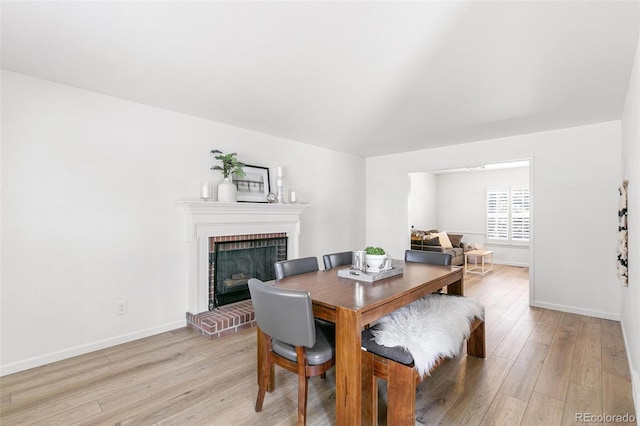 7193 S Newport Way, Centennial, CO 80112 - dining room with light wood-style floors and a fireplace