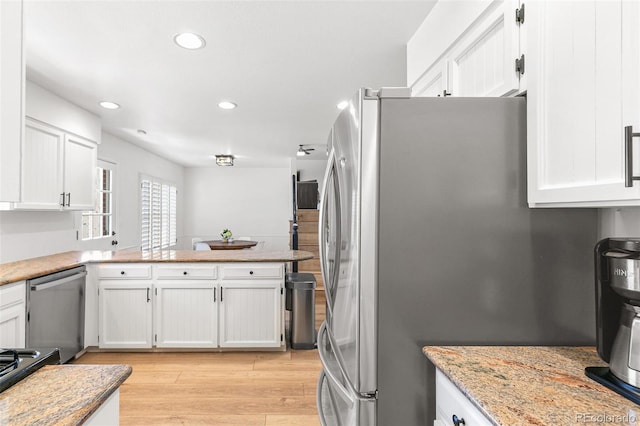 7193 S Newport Way, Centennial, CO 80112 - kitchen with stainless steel appliances, white cabinets, light wood-type flooring, recessed lighting, and a peninsula