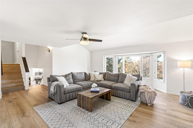 7193 S Newport Way, Centennial, CO 80112 - living room with light wood-style flooring, stairway, and ceiling fan