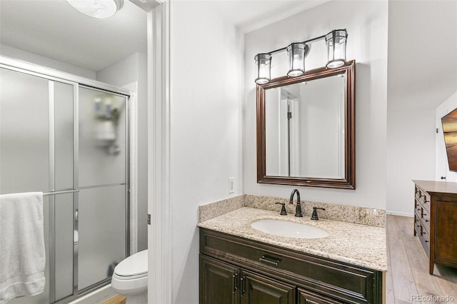 7193 S Newport Way, Centennial, CO 80112 - bathroom with vanity, a shower stall, and wood finished floors