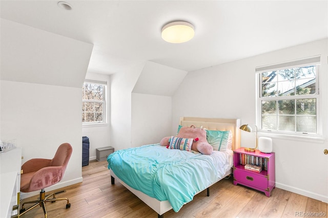 7193 S Newport Way, Centennial, CO 80112 - bedroom featuring wood-type flooring, multiple windows, and lofted ceiling