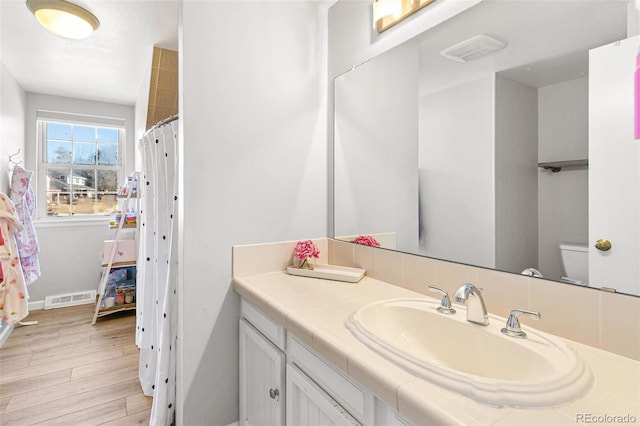7193 S Newport Way, Centennial, CO 80112 - full bath featuring vanity and wood finished floors