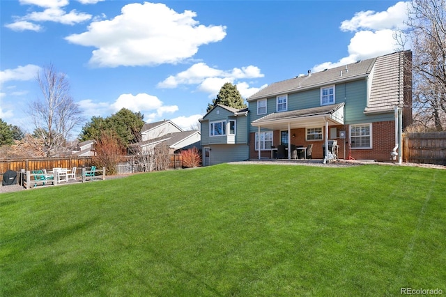 7193 S Newport Way, Centennial, CO 80112 - rear view of property featuring a fenced backyard and brick siding