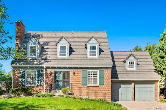 7193 S Newport Way, Centennial, CO 80112 - cape cod-style house with brick siding, a chimney, driveway, and a front yard
