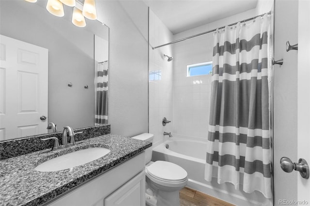 full bathroom with toilet, hardwood / wood-style floors, shower / tub combo with curtain, and vanity