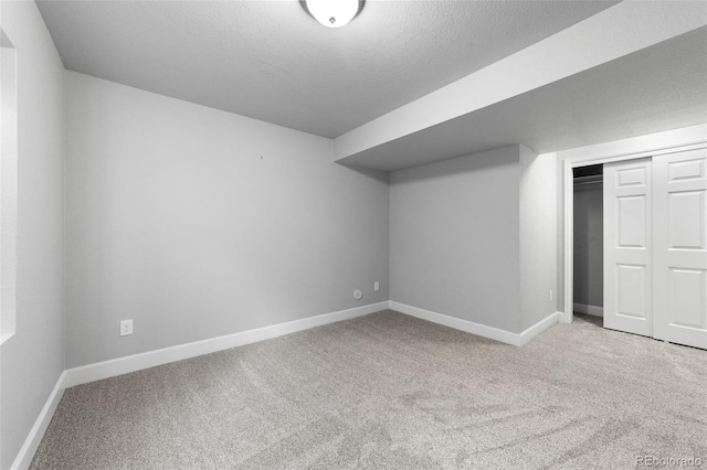 bonus room featuring a textured ceiling and carpet floors