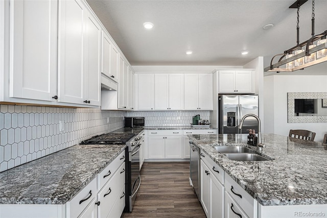 kitchen with sink, white cabinetry, dark hardwood / wood-style flooring, and stainless steel appliances