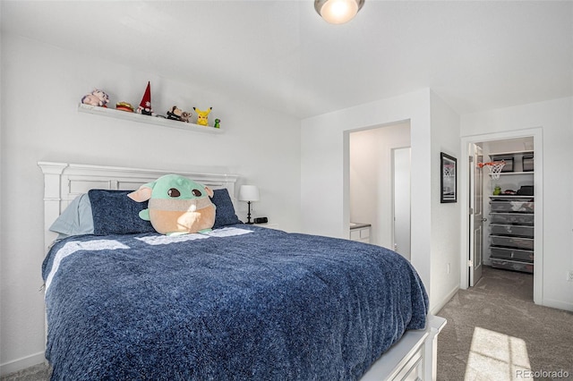 bedroom with carpet flooring, a closet, and a spacious closet