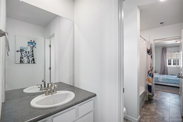 full bathroom with vanity, toilet, and shower / tub combo