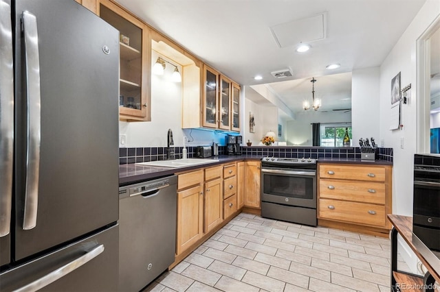 7250 Eastmoor Dr Unit 122, Denver, CO 80237 - kitchen featuring appliances with stainless steel finishes, a sink, dark countertops, recessed lighting, and glass insert cabinets