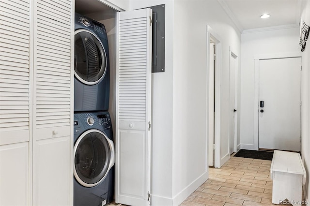 7250 Eastmoor Dr Unit 122, Denver, CO 80237 - laundry room with estacked washer and dryer, ornamental molding, baseboards, electric panel, and recessed lighting