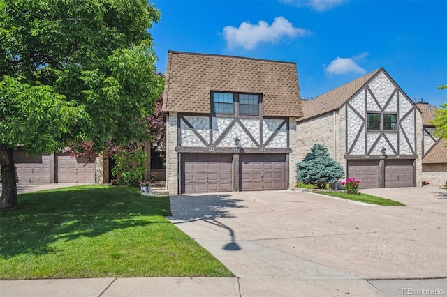 7250 Eastmoor Dr Unit 122, Denver, CO 80237 - tudor home with driveway, a garage, a front yard, and roof with shingles
