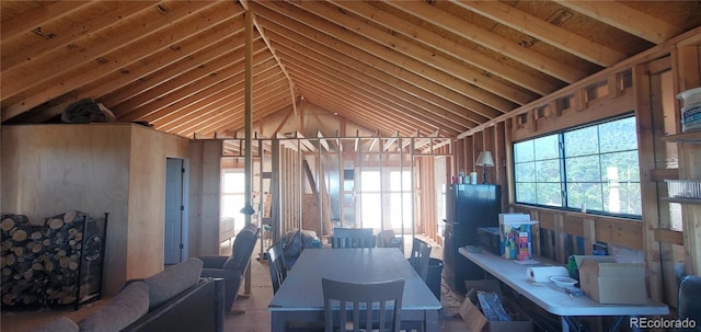 dining room with high vaulted ceiling