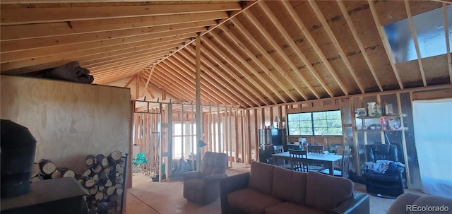 unfurnished living room featuring vaulted ceiling