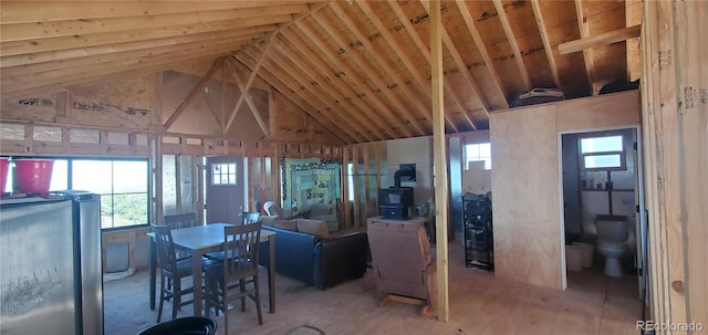 living room featuring lofted ceiling and plenty of natural light