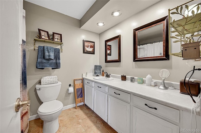 bathroom featuring baseboards, toilet, tile patterned flooring, vanity, and recessed lighting