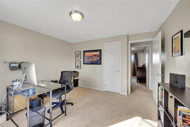 office space featuring light colored carpet and baseboards