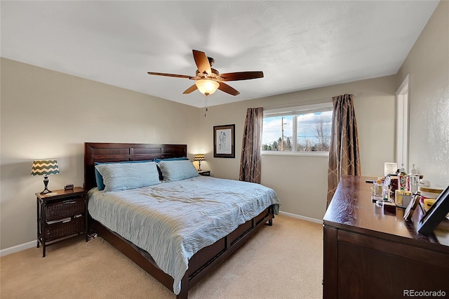 bedroom with light carpet, ceiling fan, and baseboards