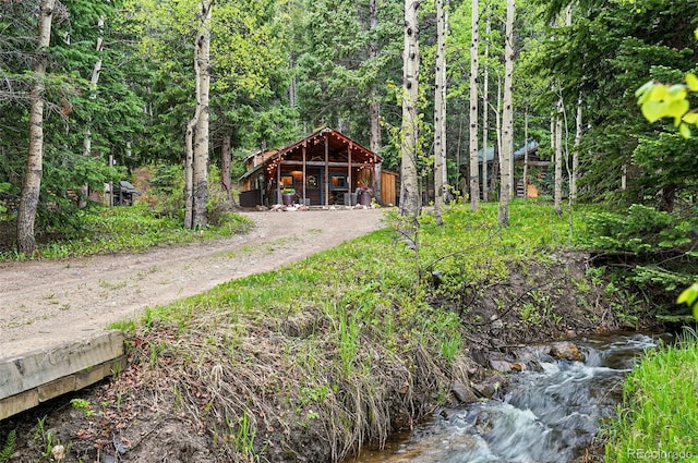 1634 Caribou Rd, Nederland, CO 80466 - view of front of property featuring a wooded view and dirt driveway