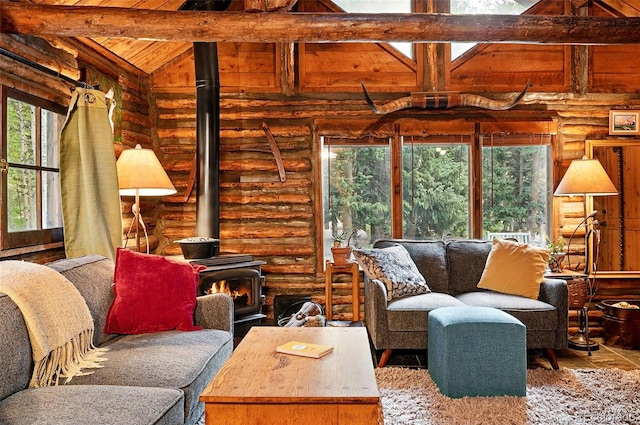 1634 Caribou Rd, Nederland, CO 80466 - living area with a wooden ceiling with exposed beams, healthy amount of natural light, a wood stove, rustic walls, and wood finished floors