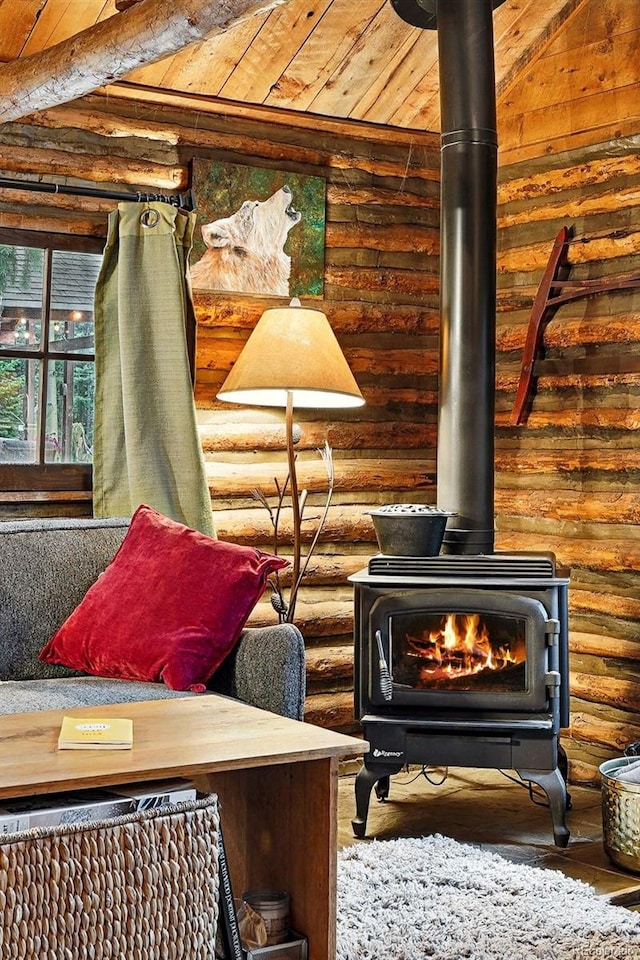 1634 Caribou Rd, Nederland, CO 80466 - sitting room featuring a wood stove, log walls, hardwood / wood-style flooring, and a wood ceiling with exposed beams