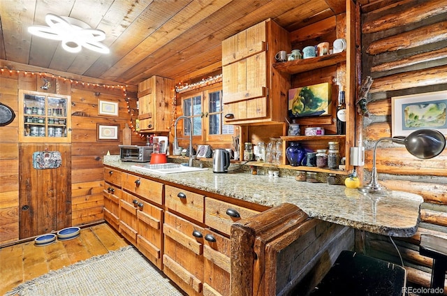 1634 Caribou Rd, Nederland, CO 80466 - kitchen featuring wooden ceiling, light wood-type flooring, open shelves, light stone countertops, and wood walls