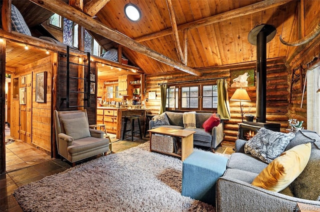 1634 Caribou Rd, Nederland, CO 80466 - living area with a wood stove, log walls, and wood ceiling