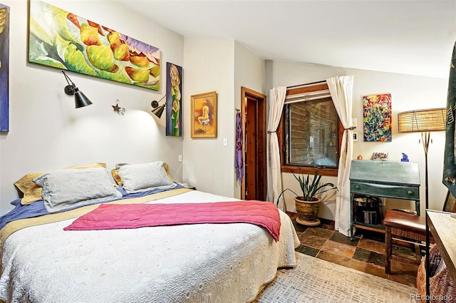 1634 Caribou Rd, Nederland, CO 80466 - bedroom featuring vaulted ceiling and stone finish floors