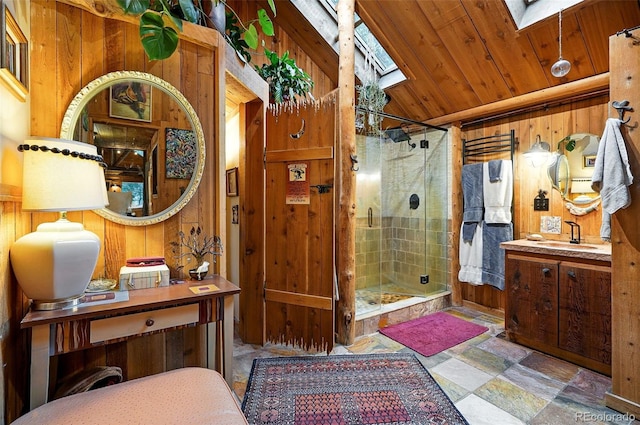 1634 Caribou Rd, Nederland, CO 80466 - full bathroom with a skylight, wooden walls, a stall shower, stone finish floors, and vanity