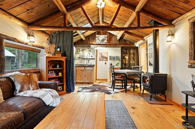 1634 Caribou Rd, Nederland, CO 80466 - living area featuring wood ceiling, light wood finished floors, and a wood stove