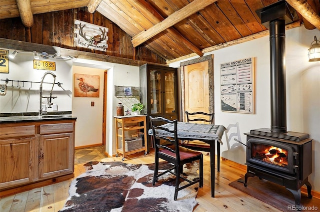 1634 Caribou Rd, Nederland, CO 80466 - dining room with a wood stove, wooden ceiling, and light wood finished floors