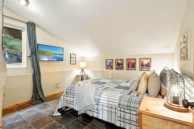 1634 Caribou Rd, Nederland, CO 80466 - bedroom featuring vaulted ceiling and stone finish flooring