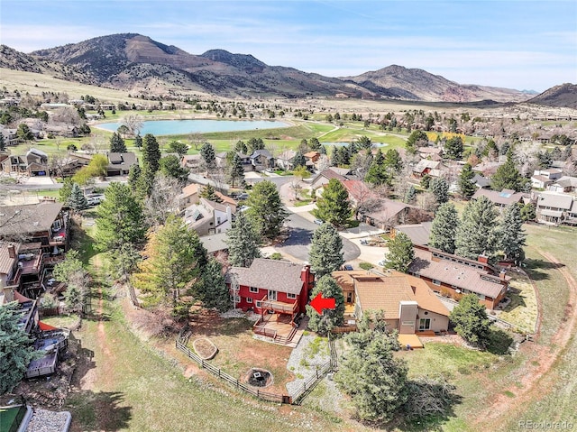 aerial view with a water and mountain view and a residential view
