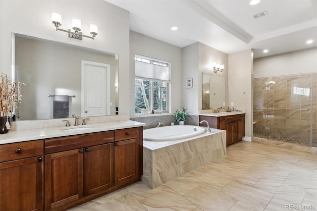 bathroom with visible vents, two vanities, a stall shower, a bath, and a sink