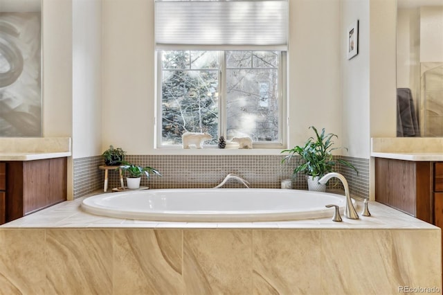 full bathroom featuring a bath and vanity