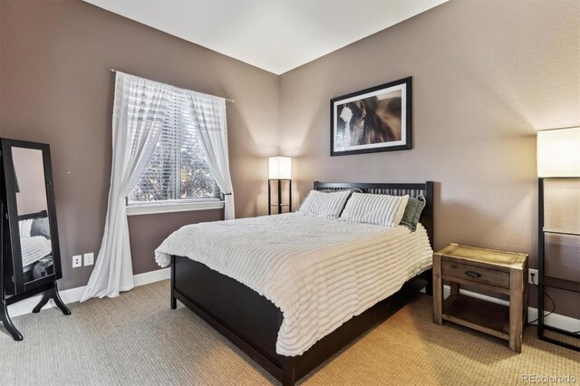 bedroom with carpet flooring and baseboards